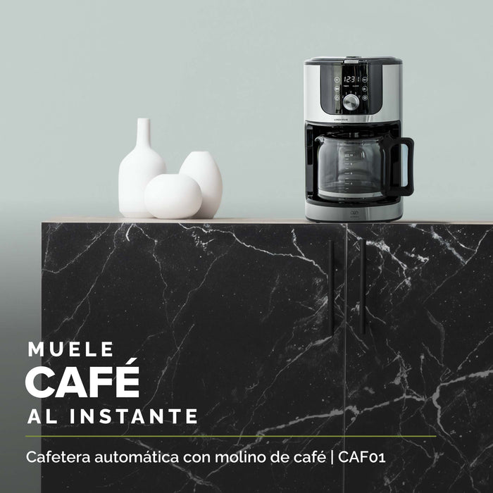 Cafetera con molino sobre la encimera en una cocina.