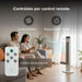 Pareja en sala usando control remoto de ventilador de torre blanco Avera con pantalla LED y 3 velocidades.