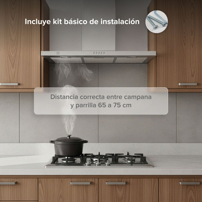 Campana de cocina de pared tipo T en acero inoxidable instalada sobre parrilla con kit de instalación incluido.